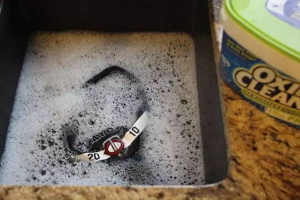 Immerse the baseball cap in water in the sink.